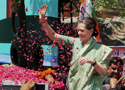 Congress President Sonia Gandhi waves to supporters as she arrives to file her nomination papers in Raebareli on Wednesday. PTI Photo