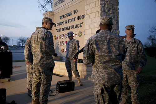 Military personnel wait for a press conference to begin at Ft. Hood, Texas, April 2, 2014. Several people were killed and at least 14 injured on Wednesday when a gunman opened fire at a U.S. Army base in Fort Hood, Texas, the site of another rampage in 2009, U.S. officials said. REUTERS