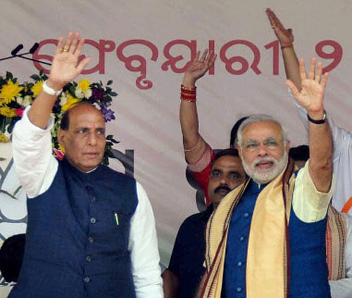 BJP's PM candidate Narendra Modi waves with party President Rajnath Singh at a public rally in Bhubaneswar. PTI Image