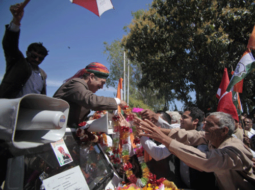 Indian Health Minister and Congress party candidate Ghulam Nabi Azad receives garlands from supporters during his election campaign at Kathua, Jammu, Ap photo