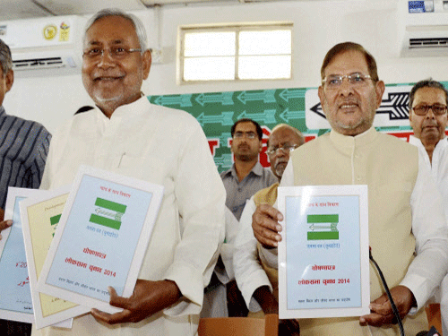 Bihar Chief Minister Nitish Kumar with party President Sharad Yadav release party manifesto in Patna on Saturday.PTI Photo