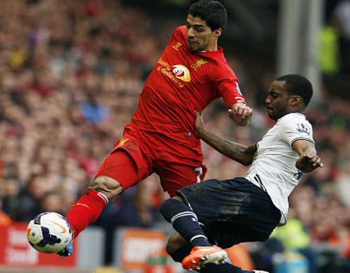 Liverpool's Luis Suarez  challenges Tottenham Hotspur's Danny Rose during their English Premier League soccer match, Reuters file photo