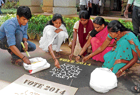 Women draw rangoli to create awareness on the importance of voting at an event organised by the BBMP in Bangalore on Friday. dh photo