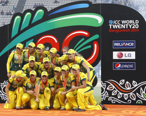 Australian players pose for a group photo while celebrating with the winner's trophy after their win over England in the ICC Women's Twenty20 Cricket World Cup final match. AP Photo