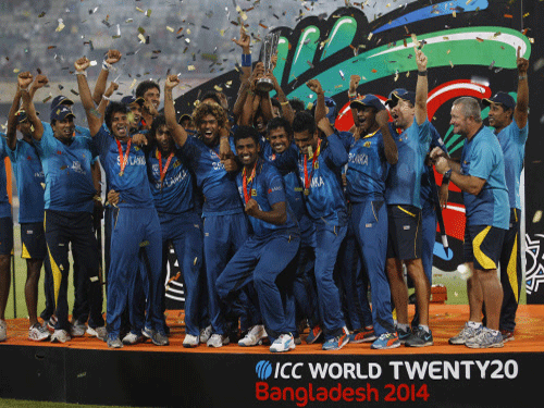 Sri Lankan players and support staff celebrate with the winners trophy after their win over India in the ICC Twenty20 Cricket World Cup final match in Dhaka, AP photo