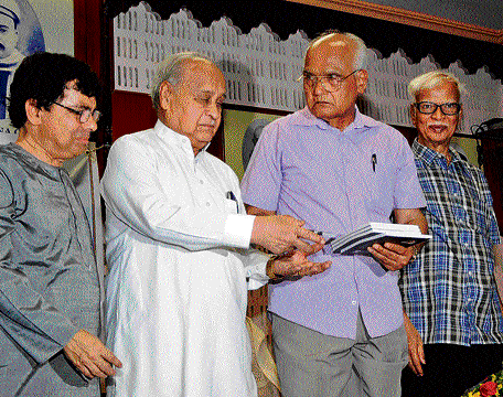 Writer S L Bhyrappa hands over a copy of the book on BJP prime ministerial candidate Narendra Modi to MP Justice M Rama Jois at an event in Bangalore on Sunday. Author of the book Mahabalamurthy Kodlekere and writer Dr Sumateendra Nadiga are seen.