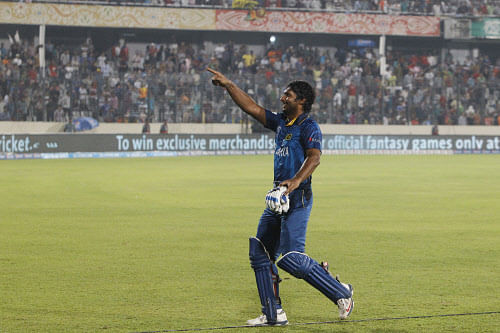 Sri Lanka's Kumar Sangakkara acknowledges the crowd after winning the ICC Twenty20 Cricket World Cup final match in Dhaka, Bangladesh, Sunday, April 6, 2014. Sangakkara struck an unbeaten 52 as Sri Lanka defeated a disappointing India by six wickets Sunday to finally win the World Twenty20 title .AP Photo