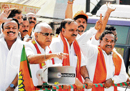 BJP leaders B S Yeddyurappa, K S Eshwarappa and H N  Ananth Kumar take part in a  roadshow in the City on  Sunday. dh Photo