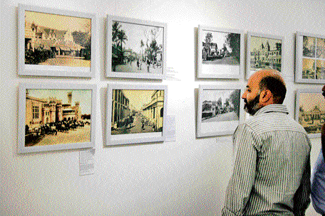 GOING BACK IN TIME: A visitor catches glimpses of the Bangalore of yore at an exhibition on Sunday. DH Photo