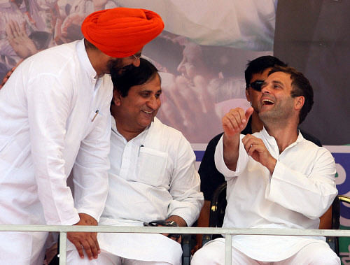 Congress vice-president Rahul Gandhi with party leader Shakeel Ahmad at an election rally in New Delhi on Sunday. PTI