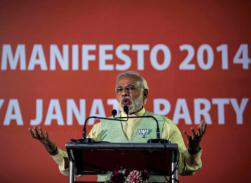 Bharatiya Janata Party (BJP)'s prime ministerial candidate Narendra Modi speaks during the release of the party's manifesto in New Delhi, Monday, April 7, 2014. AP photo
