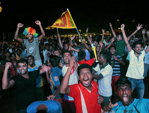 Sri Lanka cricket fans carry their national flag in Colombo, Sri Lanka, as they celebrate while watching on television Sri Lanka's victory in the ICC Twenty20 Cricket World Cup final. AP Photo