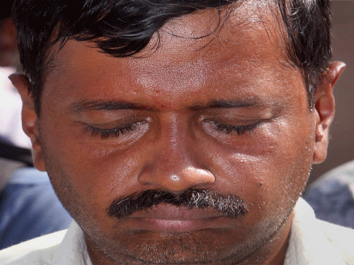 AAP convener Arvind Kejriwal sitting at a silent prayer at Mahatma Gandhi's samadhi Rajghat after he was slapped by an autorickshaw driver in an election road show in New Delhi on Tuesday. PTI Photo