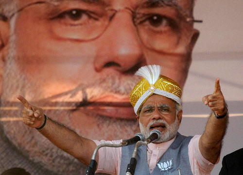 BJP PM candidate Narendra Modi wearing a Mysore peta, addresses an election rally in Mysore on Tuesday. PTI Photo