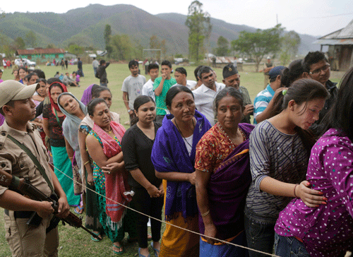 People stand in line to cast their votes at a voting center in Kalapahar, Manipur on Wednesday, April 9, 2014. AP