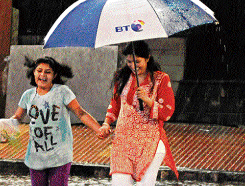 surprise showers: People were caught unawares as sudden rain on Wednesday  evening brought the much-needed respite from soaring mercury levels. dh Photo / S K DINESH