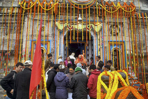 Priests along with temple committee members perform prayers at the Kedarnath temple in Uttarakhand. PTI file photo