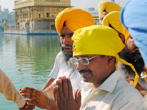 Arvind Kejriwal during a visit to the Golden Temple in Amritsar. Kejriwal offered prayers here before starting his election tour. PTI Photo