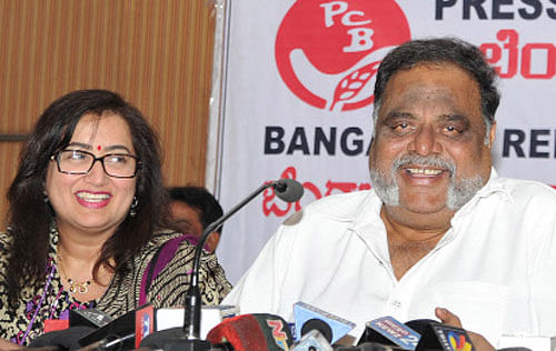Housing Minister M H Ambarish addresses a press meet in Bangalore on Friday as wife, Sumalatha, smiles. DH photo