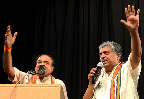 Bangalore South Lok Sabha Election Candidates BJP Ananth Kumar and Congress Nandan Nilekani request to their party workers to cool down during an event of 'Candidates Meets with Citizens' organised by B.Pac in Bengaluru on Saturday. PTI Photo