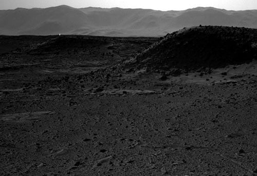This image taken by NASA's Curiosity Mars rover's right-eye camera of the stereo Navcam on April 3, 2014 includes a bright spot, upper left, which might be due to the sun glinting off a rock or cosmic rays striking the camera's detector. Bright spots appear in images from the rover nearly every week. Typical explanations for them are cosmic rays hitting the light detector or sunlight glinting from rocks. AP