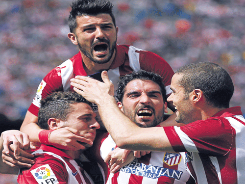 The key factors behind Atletico Madrid's success are team spirit and sheer willpower. Reuters photo