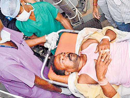 An injured poll duty official being taken to a hospital in Raipur. REUTERS