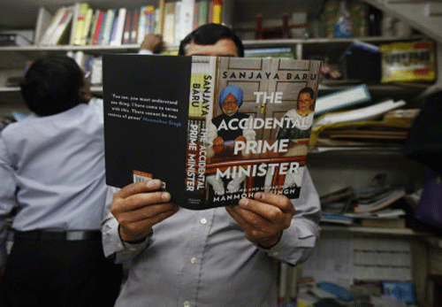 A man goes through a copy of 'The Accidental Prime Minister: The Making and Unmaking of Manmohan Singh,' at a book shop in New Delhi, India, Saturday, April 12, 2014. The new book by the prime minister's former aide has caused a political stir during ongoing national elections by suggesting the outgoing leader was never fully in charge of his government and describes a frustrated Singh as having to compete with Congress Party leader Sonia Gandhi for influence within his own Cabinet. Singh's office slammed the book, saying it 'smacks of fiction and colored views of a former adviser' gathered during the first five of Singh's 10 years in office. AP photo