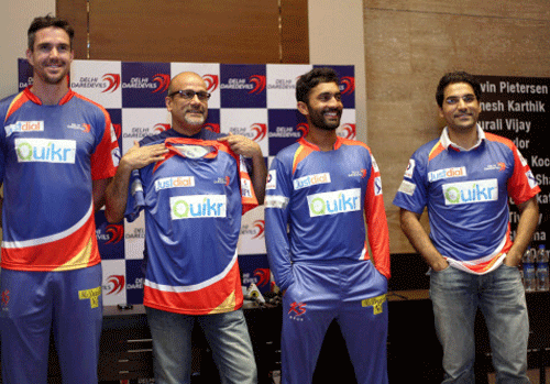 Delhi Daredevils captain K Pietersen (ext left) along with team CEO Hemant Dua and vice captain Dinesh Karthik at the unveiling of their new jersey in New Delhi. PTI Photo