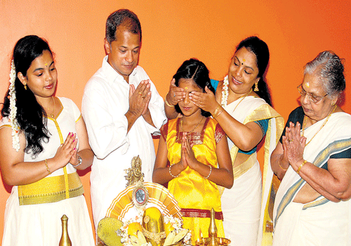 From left: Priyanka, Prakash, Kavya, Hemelatha and Kalyaniamma near the Vishu Kani.  DH photo