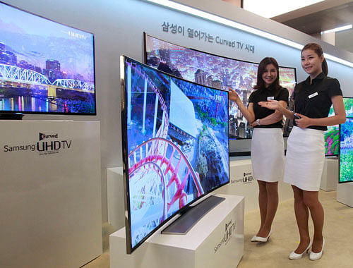 Models  posing with a Samsung Electronics curved UHD TV in Seoul, South Korea. AP file photo