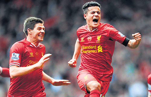 Liverpool's Philippe Coutinho (centre) celebrates after scoring the winner against Manchester City. AP photo