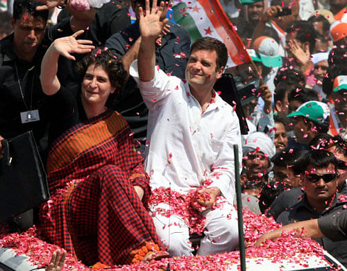 Congress Vice President Rahul Gandhi with his sister Priyanka Vadra waves to supporters on the way to file his nomination papers for Amethi parliamentary seat, in Amethi on Saturday. PTI Photo