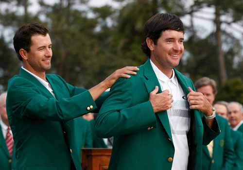 Masters champion Bubba Watson of the U.S. is helped with his traditional green jacket by last year's champion Adam Scott of Australia (L) after the final round of the Masters golf tournament at the Augusta National Golf Club in Augusta, Georgia. Reuters photo