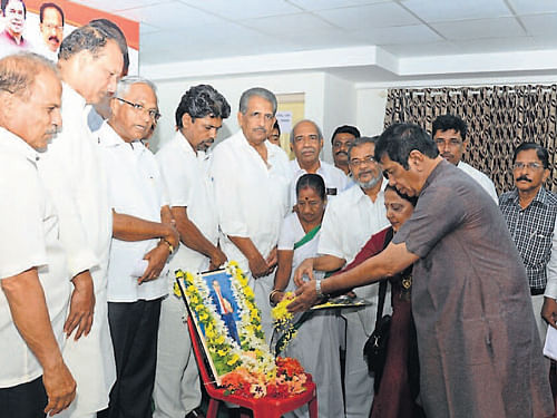 Union Minister for Road Transport and Highways Oscar Fernandes pays a floral tribute to the portrait of B R Ambedkar on the occasion of his 123rd birth anniversary, at the party election office in Mangalore, on Monday. DH Photo