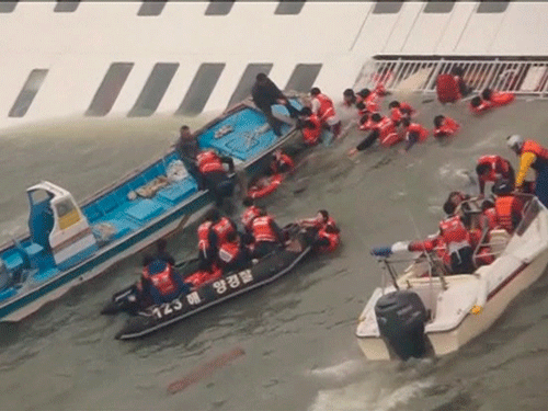 Members of the South Korean coast guard rescue passengers from the water next to a partially sunken ferry, off South Korea's southwest coast in this still image from a video released by the South Korean coast guard April 16, 2014. More than 280 people, many of them students from the same high school, were missing after a ferry capsized off South Korea on Wednesday, in what could be the country's biggest maritime disaster in over 20 years. REUTERS
