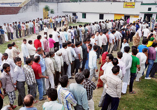 Voters stand in queue to cast their vote for Lok Sabha elections in Moradabad on Thursday.PTI Photo