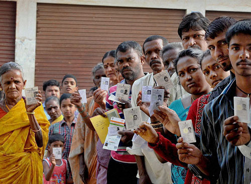 Voters wait in a queue to cast votes for the Lok Sabha elections in Chikmagalur on Thursday. PTI Photo