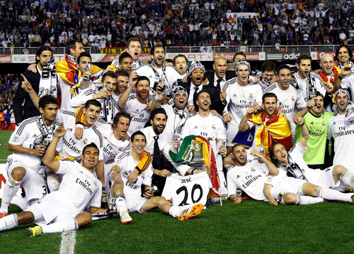 Real Madrid players celebrate with the trophy after winning the King's Cup final soccer match against Barcelona at Mestalla stadium in Valencia. Reuters photo