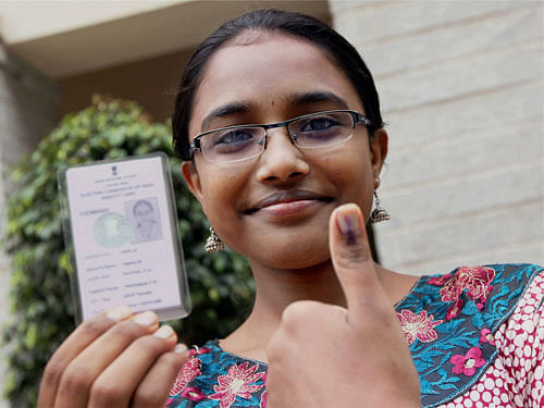A first timer voter shows her inked thumb after casting vote for Lok Sabha polls in Bengaluru on Thursday. PTI Photo