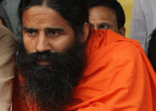 In an embarrassment for Ramdev, the Yoga Guru was caught on tv camera murmuring to BJP candidate Mahant Chandnath not to talk about money when mics are on after the latter told him that he was running short of money during electioneering in Alwar constituency. PTI photo