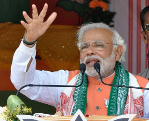 Narendra Modi today fired a fresh salvo at Sonia Gandhi and Rahul Gandhi, saying the country cannot be run by 'remote control'  and the mother-son duo will have to pay a 'price' for running the UPA government from behind the scene. / PTI Photo