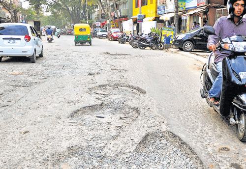 Motorists struggle to navigate a stretch of Double Road in  Indiranagar. DH photo