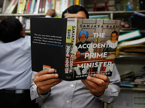 A man goes through a copy of 'The Accidental Prime Minister: The Making and Unmaking of Manmohan Singh,'. AP Photo