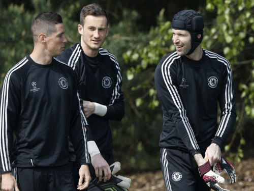 Chelsea players Petr Cech, right, and Fernando Torres, left, arrive for a training session at Cobham in England, Monday, April 21, 2014. Chelsea will play in a Champions League semifinal soccer match against Atletico Madrid. AP Photo