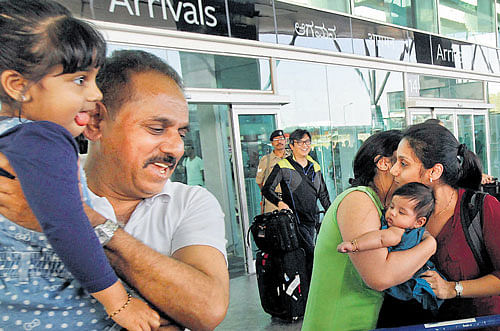 Relatives receive passengers of MH192 at the KIA in Bangalore on Monday. PTI