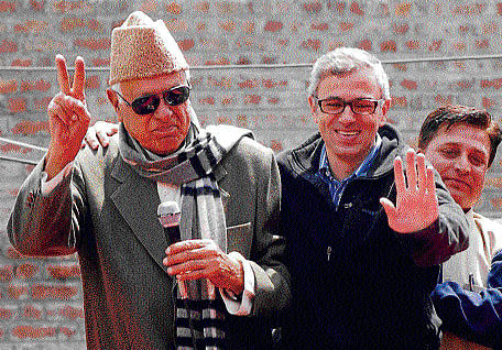 Union minister and NC president Farooq Abdullah with his son, Jammu and Kashmir Chief Minister Omar Abdullah at Ganderbal on Wednesday. PTI