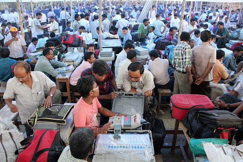 Polling officials checking Electronic Voting Machines (EVM) at a distribution centre for Lok Sabha elections at Balurghat in South Dinajpur district of West Bengal on Wednesday. PTI