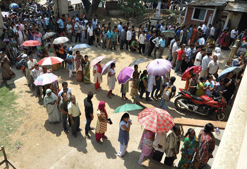 Guwahati: People stand in queues to cast their votes for Lok Sabha elections at a polling station, in Guwahati on Thursday. PTI Photo