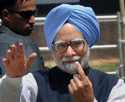 Dispur: Prime Minister Manmohan Singh showing the ink mark on his finger after casting vote for Lok Sabha polls at Dispur in Assam on Thursday. PTI Photo